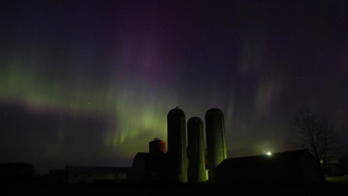 The northern lights are seen over a farm near Pulaski, Wisconsin, on Sunday. — AP