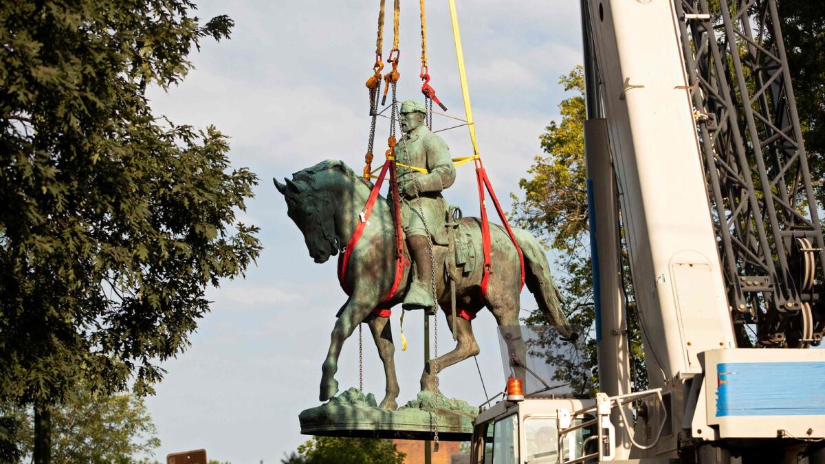 Workers remove the statue of Confederate General Robert E. Lee from a park in Charlottesville, Virginia, on Saturday.