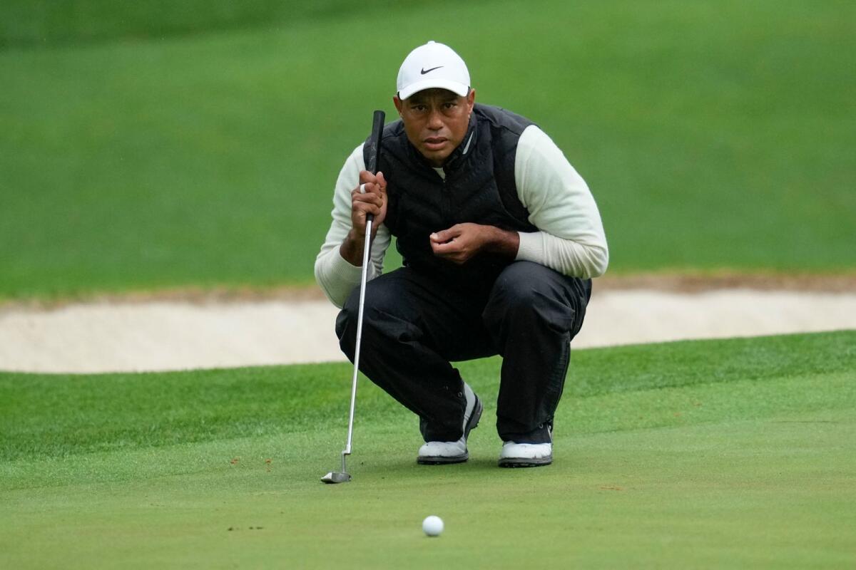 Tiger Woods lines up a putt  during the second round of the Masters on April 8. — AP file
