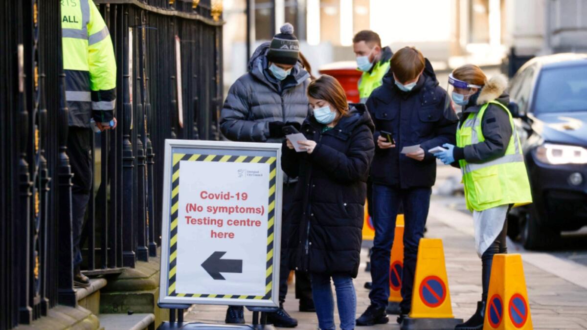 People queue outside a coronavirus disease (COVID-19) testing centre in Liverpool, Britain. — Reuters