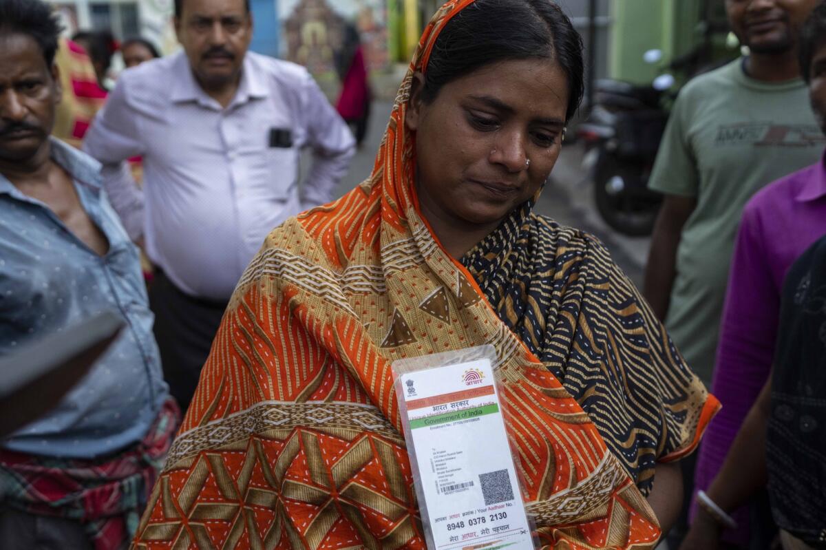 Bulti Khatun, whose husband is missing cries as she holds his Aadhaar card at a hospital in Balasore district, in the eastern state of Orissa, India, on Sunday. Photo: AP