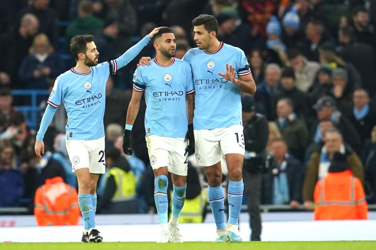 Manchester City's Riyad Mahrez (centre) celebrates with teammates after scoring his side's third goal. — AP