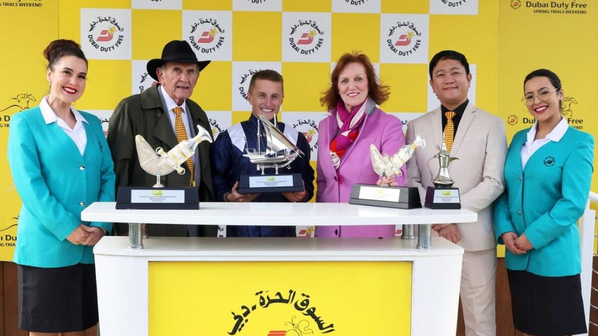 Tom Marquand receives his trophy from Colm McLoughlin, Sinead El Sibai and Bernard Aquino after the Group 3 Dubai Duty Free Finest Surprise Stakes- Photo Dubai Duty Free