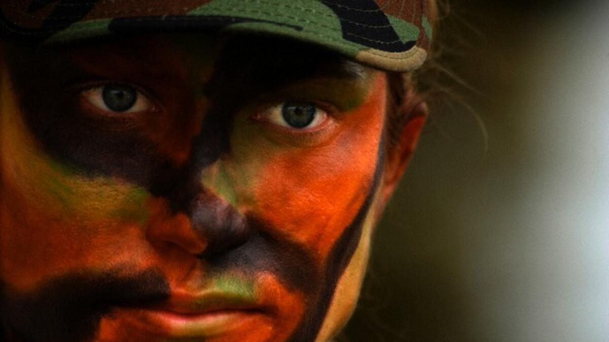 Close-up of US Air Force soldier with camouflage face paint.