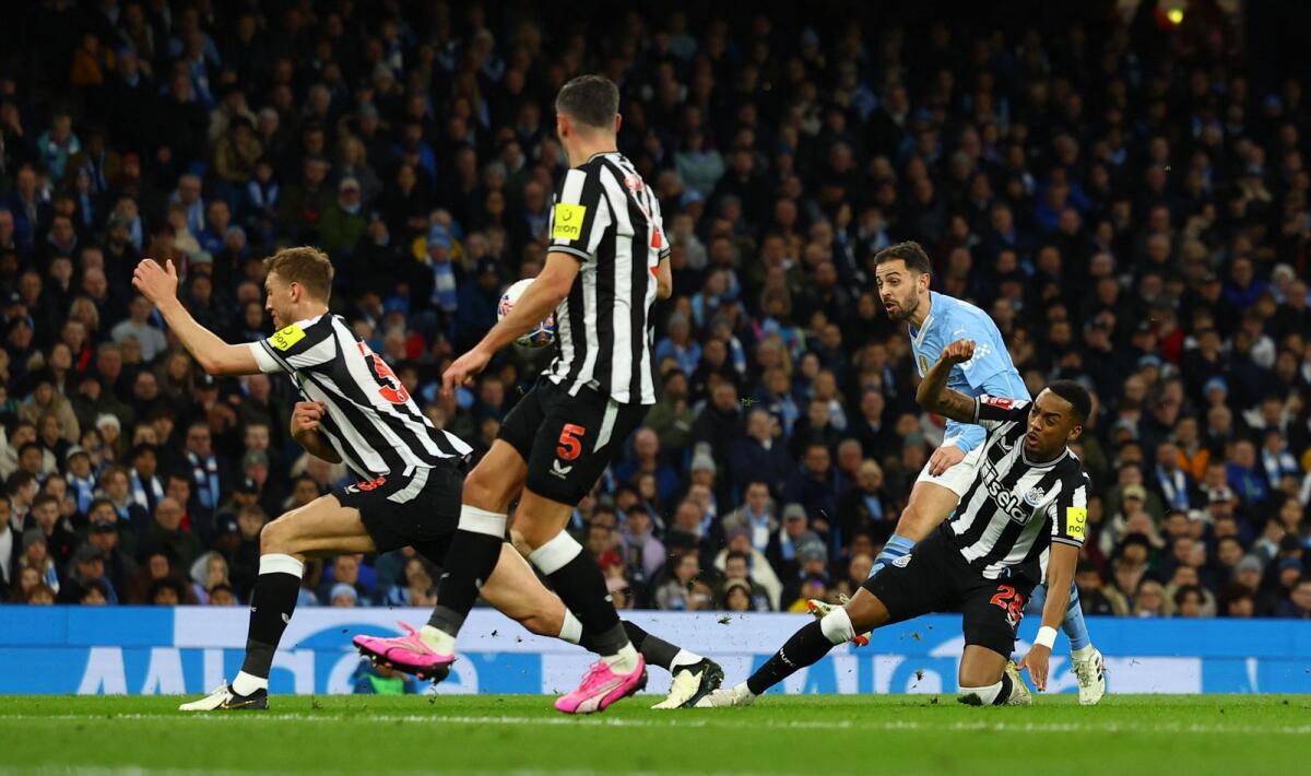 Manchester City's Bernardo Silva scores their first goal via a deflection off Newcastle United's Dan Burn. - Reuters