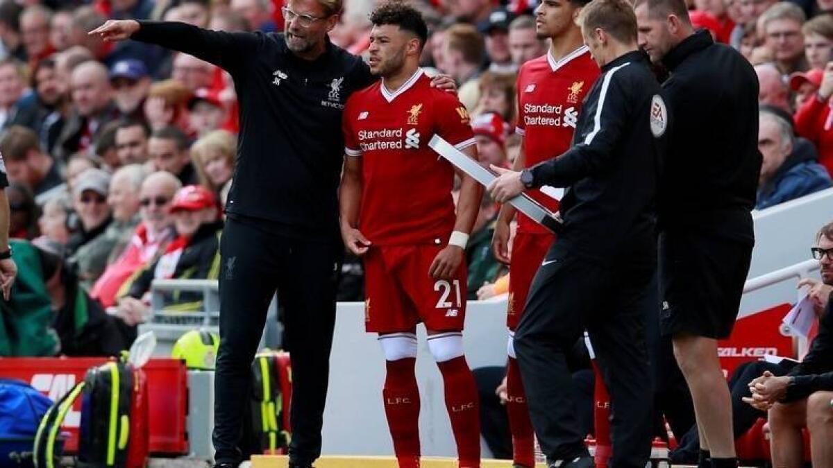 Liverpool manager Juergen Klopp with substitute Alex Oxlade-Chamberlain during a Premier League match. - Reuters file