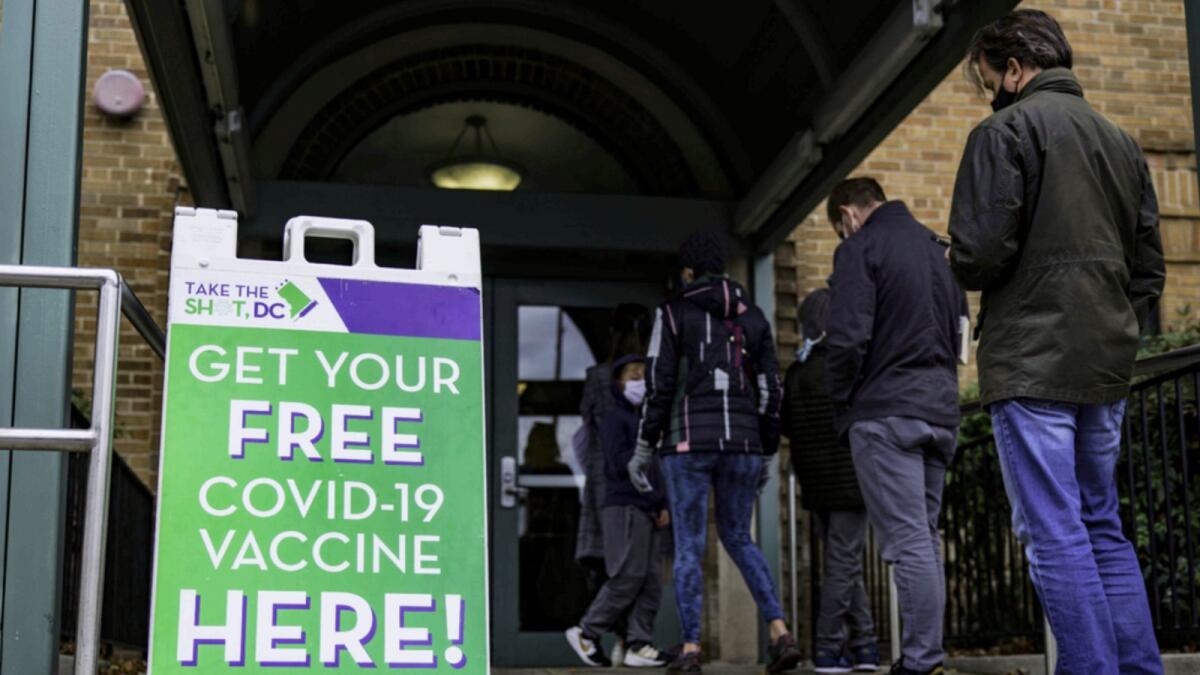 People line up outside of a free Covid-19 vaccination site in the Hubbard Place apartment building in Washington. — AFP
