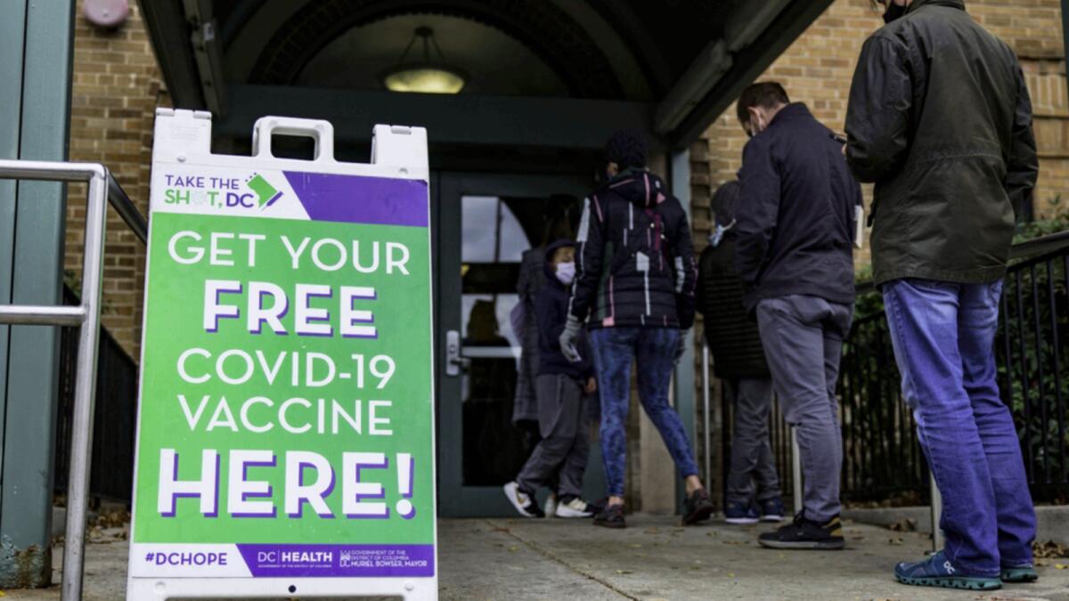 People line up outside of a free Covid-19 vaccination site in the Hubbard Place apartment building in Washington. — AFP