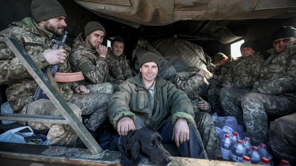 Ukraine's Military Forces servicemen sit in the back of military truck in the Donetsk region town of Avdiivka. (AFP)