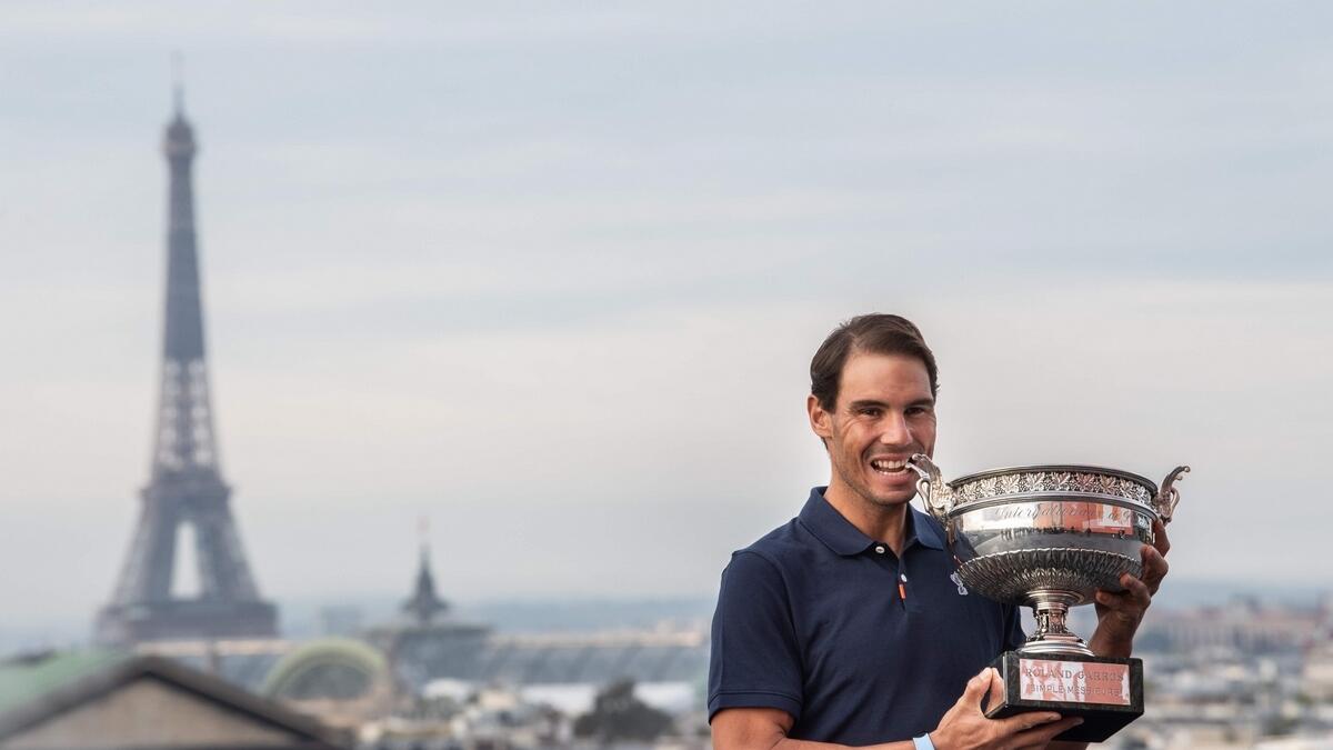 Rafael Nadal holds the Mousquetaires Cup (The Musketeers) during a photocall a day after winning the French Open