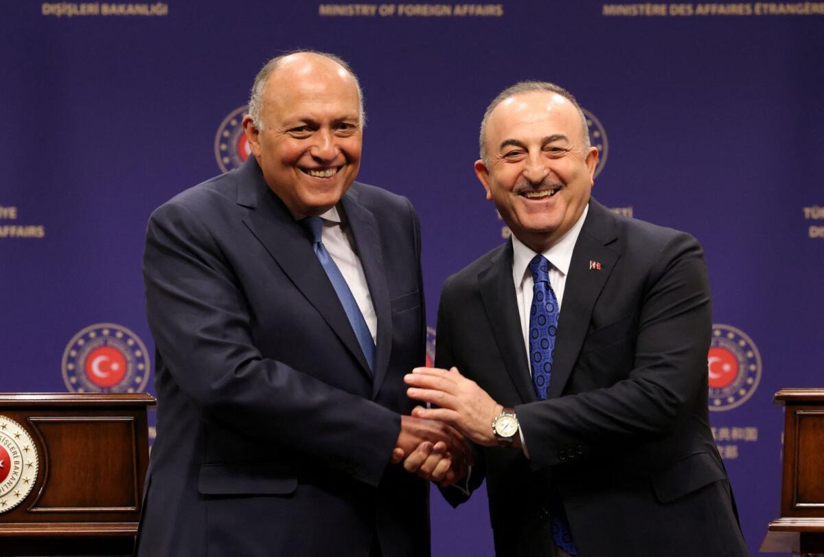 Turkish Foreign Minister Mevlut Cavusoglu and Egyptian Foreign Minister Sameh Shoukry shake hands during a news conference in Ankara, Turkey, on Thursday. — Reuters