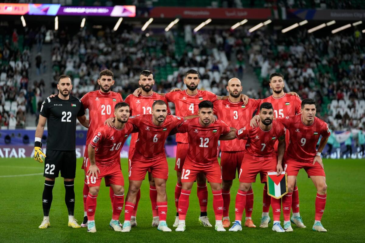 Palestine players pose ahead of the Asian Cup match against Iran at the Education City Stadium in Al Rayyan, Qatar, on Sunday. — AP
