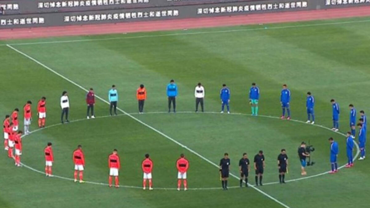 Reigning champions Guangzhou Evergrande and FA Cup winners Shanghai Shenhua maintain a minute's silence prior to the start of the Chinese Super League. -- Twitter