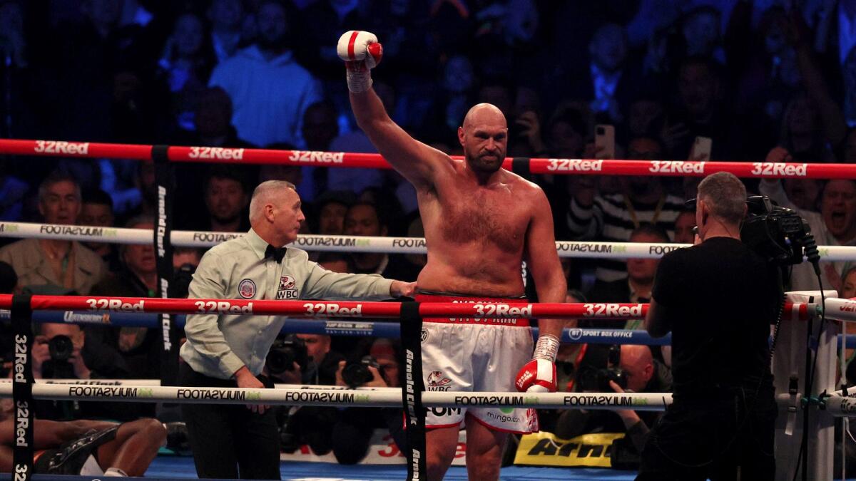 Britain's Tyson Fury (R) celebrates after knocking out Britain's Dillian Whyte. Photo: AFP