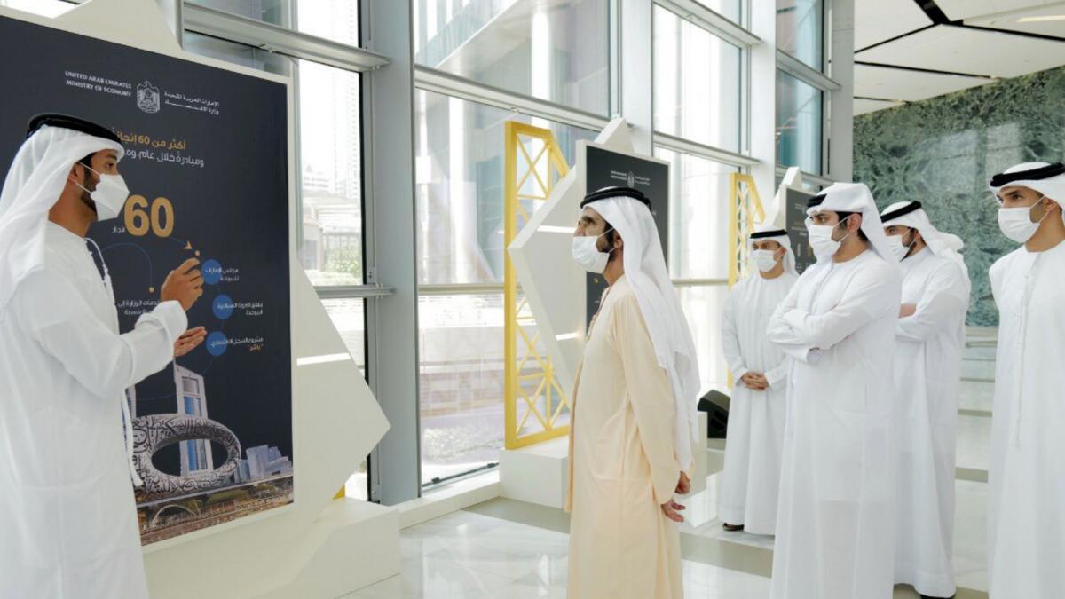 Sheikh Mohammed being briefed on the new initiatives at the Ministry of Economy on Monday.