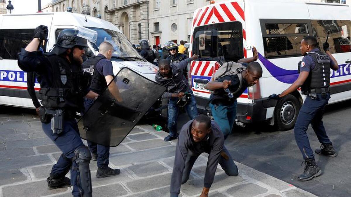Riot police officers clash with undocumented migrants outside the Pantheon in Paris, France, July 12, 2019. Reuters
