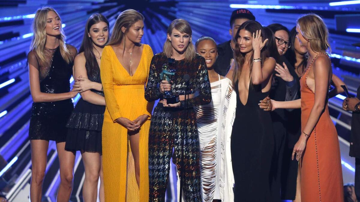 Taylor Swift wins big, Kanye rants, Miley flashes flesh at MTV awards