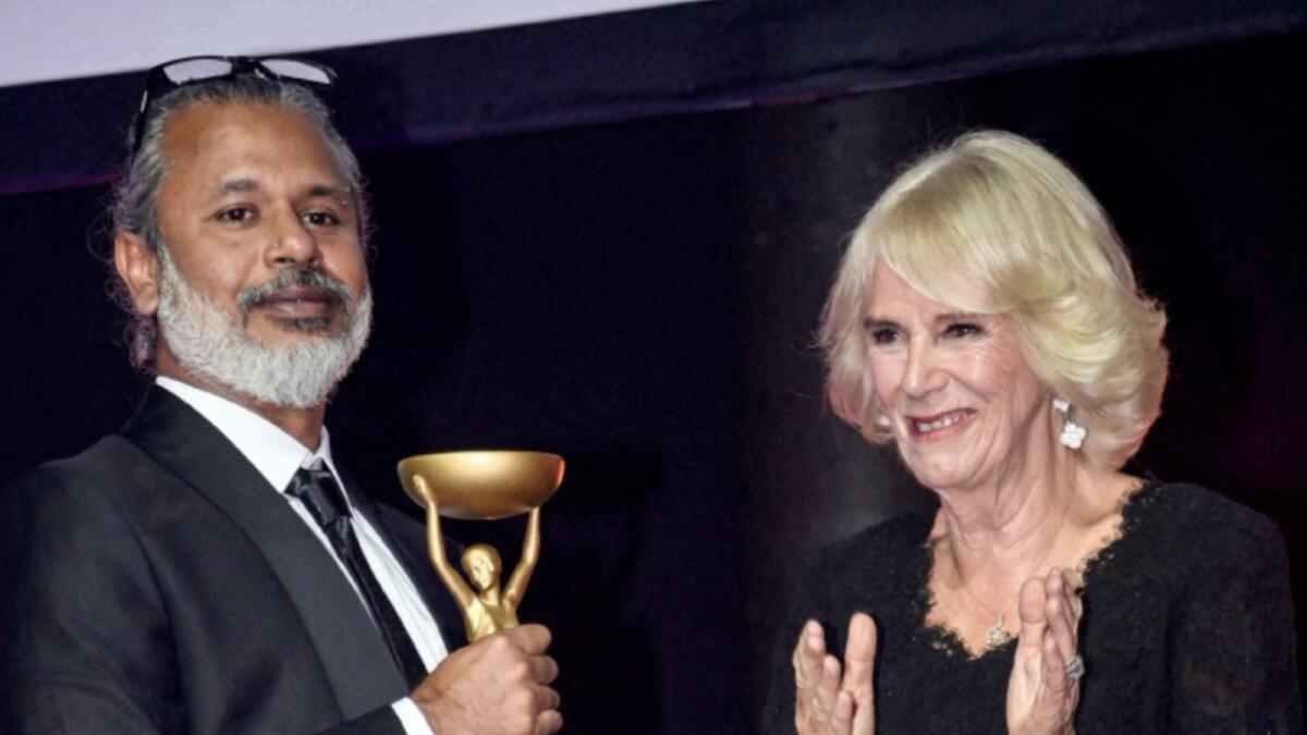 Sri Lankan writer Shehan Karunatilaka poses next to Britain's Camilla, Queen Consort  after winning the British Booker Prize for his novel 'The Seven Moons of Maali Almeida'. — AFP