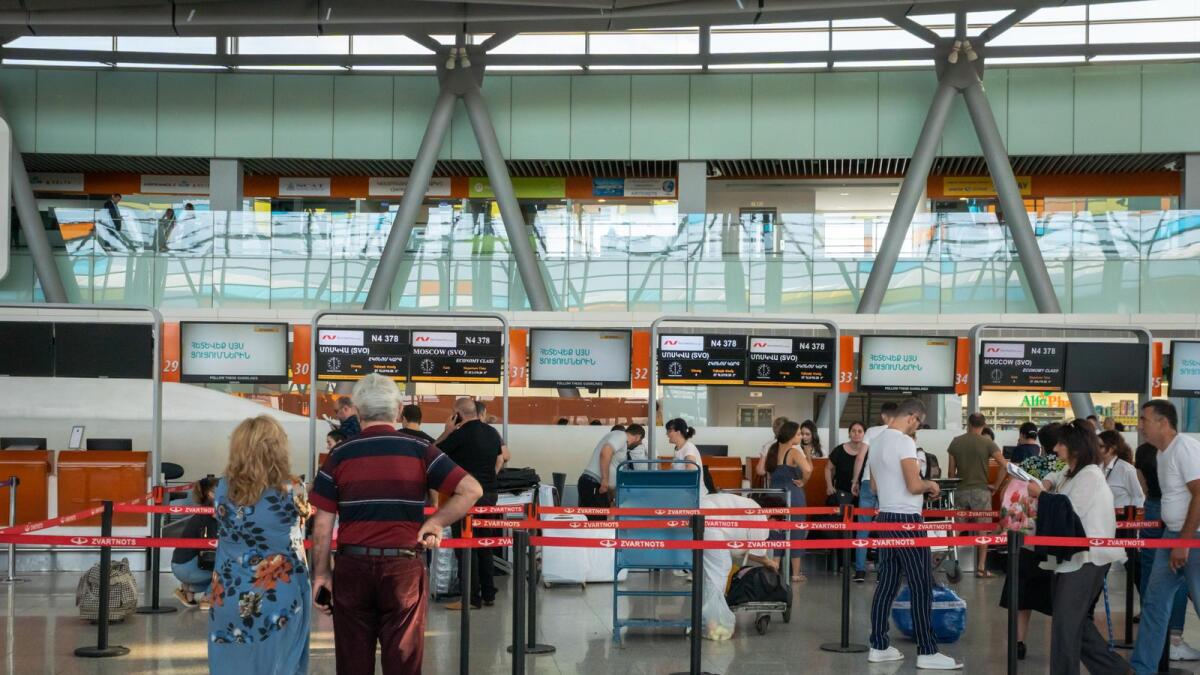 Passengers in check-in counter area at Yerevan Zvartnots International Airport. Photo: Alamy