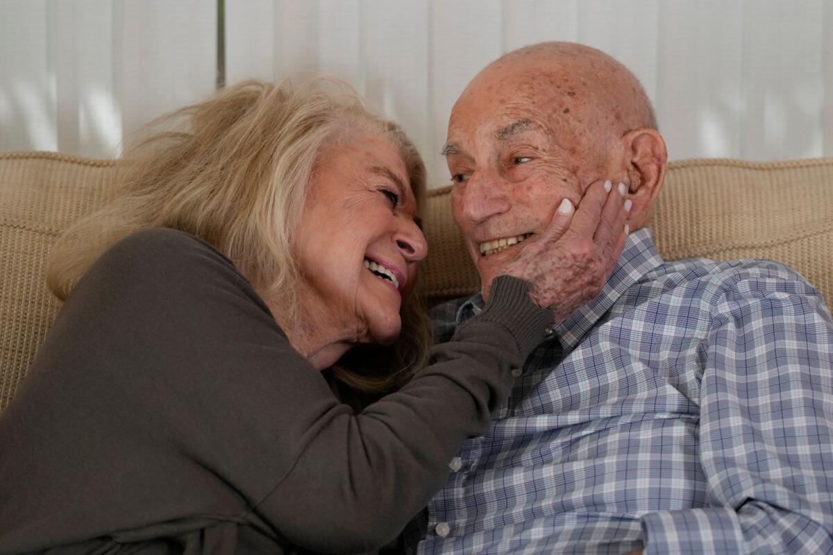 World War II veteran Harold Terens, 100, right, and Jeanne Swerlin, 96, snuggle during an interview, on February 29, 2024, in Boca Raton, Florida. Terens will be honoured by France as part of the country's 80th anniversary celebration of D-Day.— AP