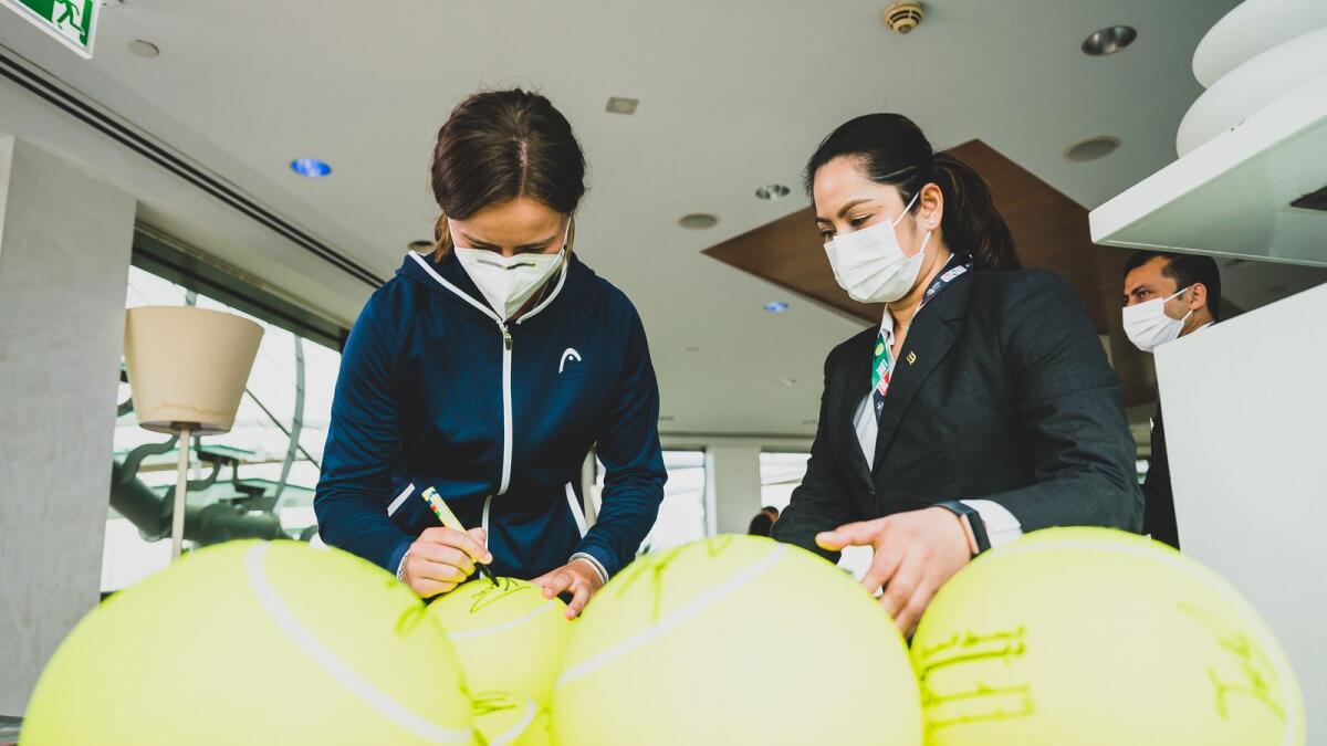 Barbora Krejcikova signing tennis balls ahead of the Dubai Duty Free Tennis Championships. (Photo by Neeraj Murali)