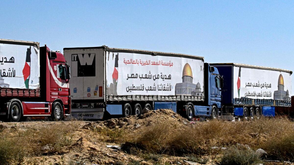Egyptian trucks carrying humanitarian aid bound for the Gaza Strip wait near the Rafah border crossing on the Egyptian side. — AFP