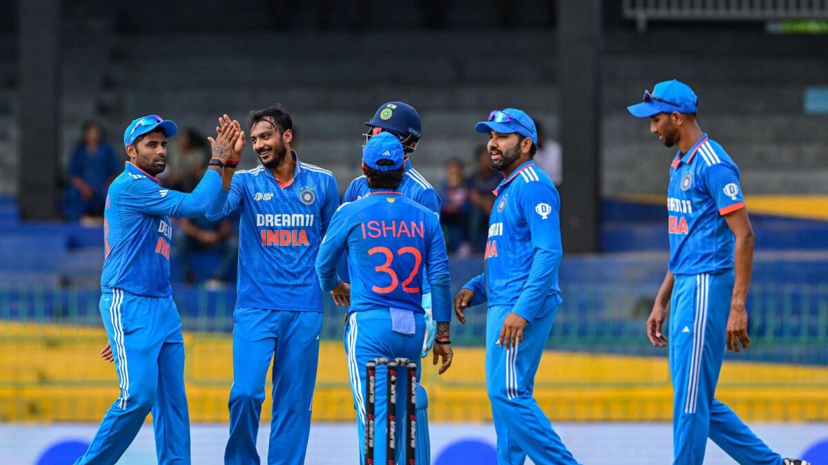 India's Axar Patel (left) celebrates with teammates after taking the wicket of Bangladesh's Mehidy Hasan Miraz in the Asia Cup. — AFP
