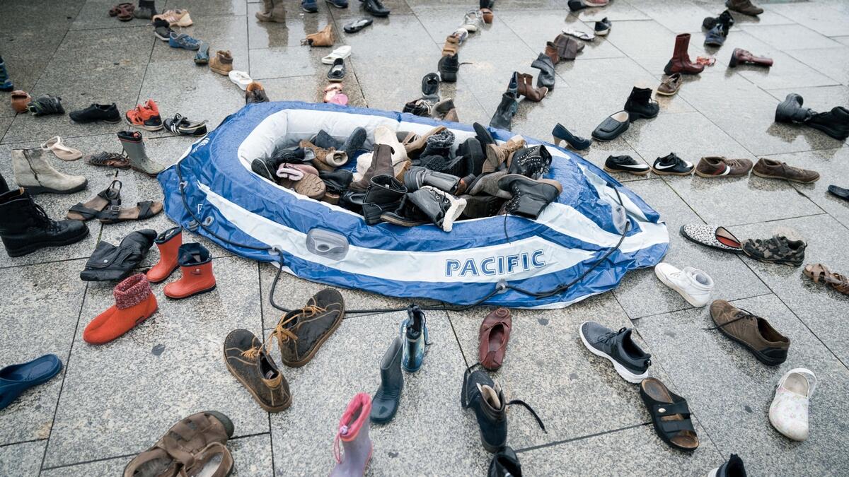 A rubber dinghy and around 200 pairs of shoes lie in the station forecourt as an installation for a vigil for the 5th anniversary of the death of child migrant Alan Kurdi. The body of 3-year-old Syrian Alan Kurdi was found on a Turkish beach after the small rubber boat he, his 5-year old brother Galib and their mother, Rehan, were in capsized during a desperate voyage from Turkey to Greece. The vigil was organized by the aid organization 'Sea Eye'. Photo: AP