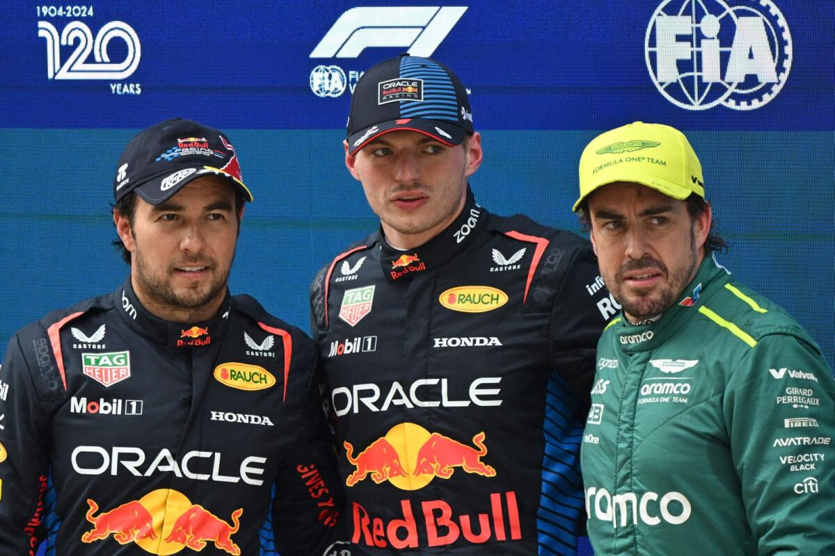 (L-R) Red Bull Racing's Mexican driver Sergio Perez, Red Bull Racing's Dutch driver Max Verstappen and Aston Martin's Spanish driver Fernando Alonso pose aat the Chinese Grand Prix at the Shanghai International Circuit. - AFP