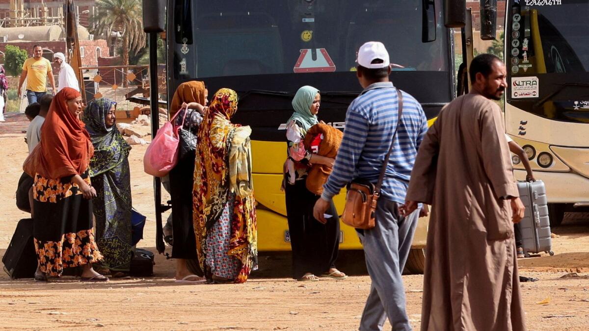 Sudanese and people from other nationalities evacuated from Khartoum wait to board a bus to catch a ferry to cross the River Nile to Abu Simbel city, at the upper reaches of the Nile in Aswan, Egypt, April 26, 2023. — Reuters