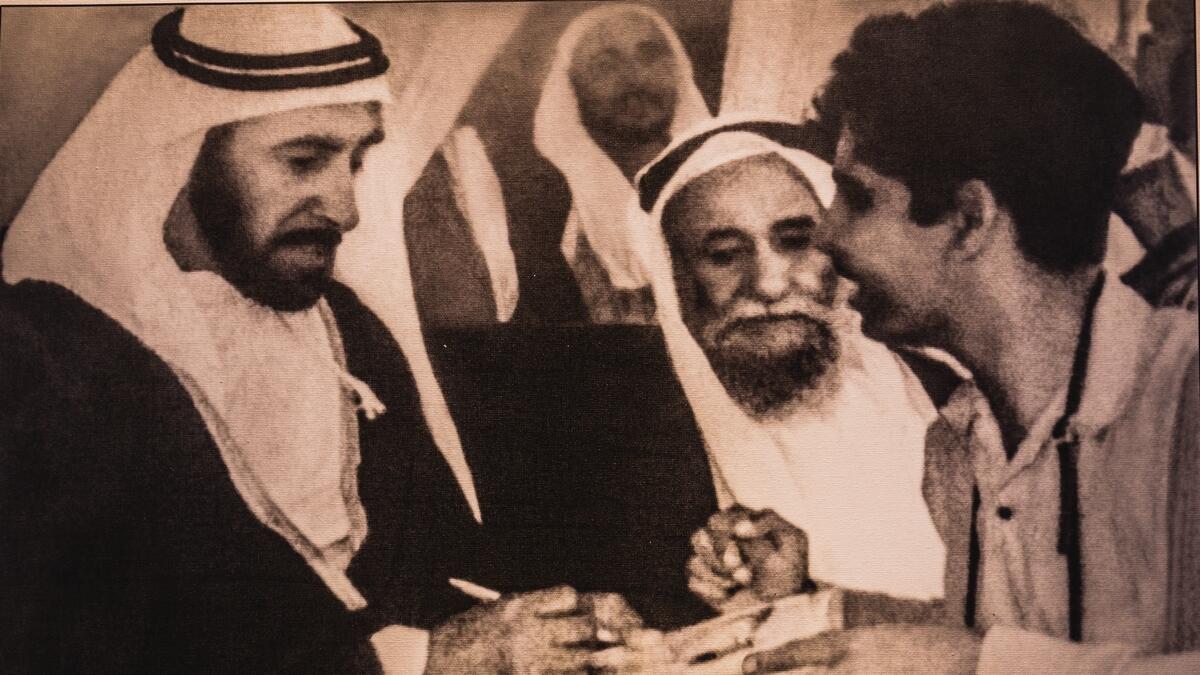 A photograph of Ramesh Shukla getting an autograph from late Sheikh Zayed is on display at the photo exhibition.-Photo by Neeraj Murali 