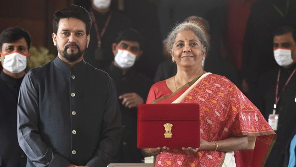 Finance Minister Nirmala Sitharaman holds a folder case containing the Union Budget 2021-22 with Anurag Thakur, Minister of State for Finance. — PTI