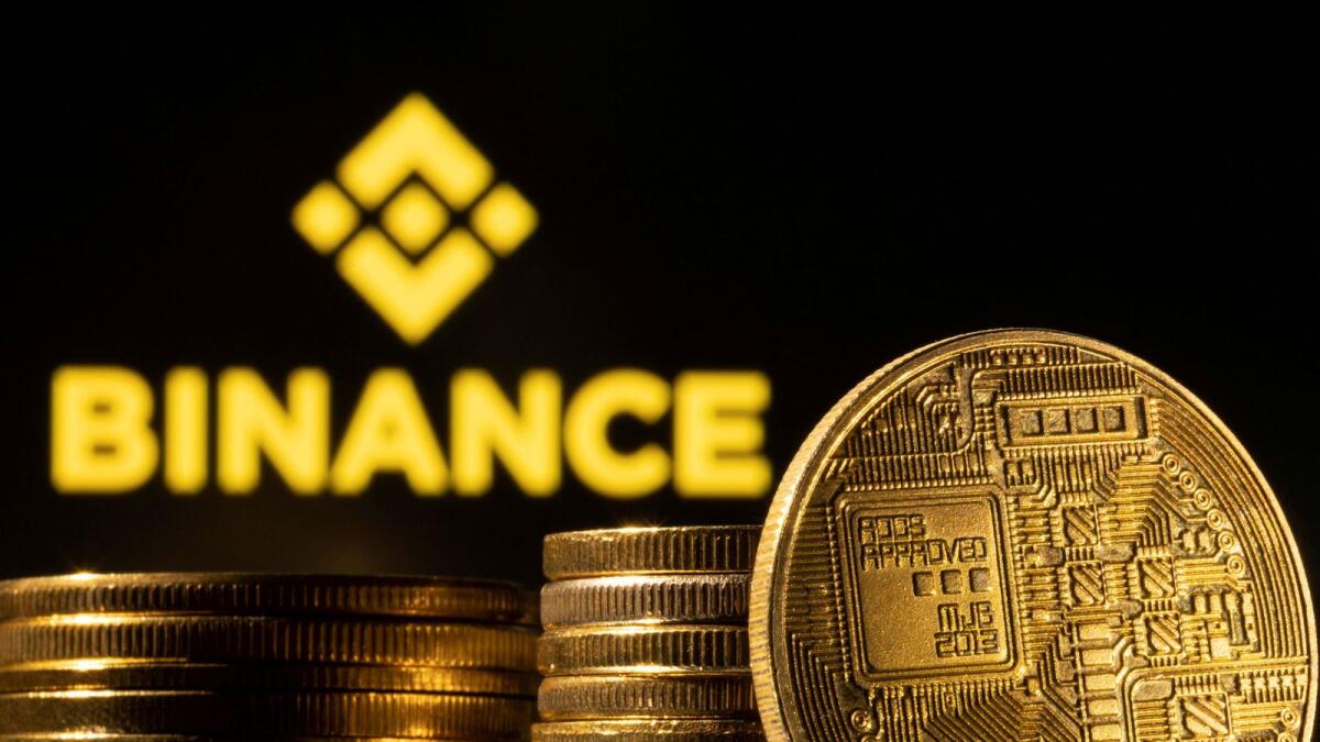 FILE PHOTO: A representation of the cryptocurrency is seen in front of Binance logo in this illustration taken, March 4, 2022. REUTERS/Dado Ruvic/Illustration/File Photo