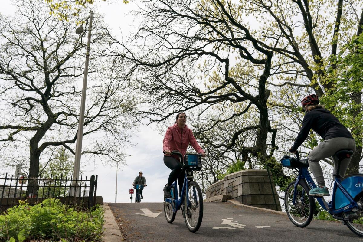 Cyclists ride along the Hudson River Greenway in New York, May 8, 2022.  — Karsten Moran/The New York Times)