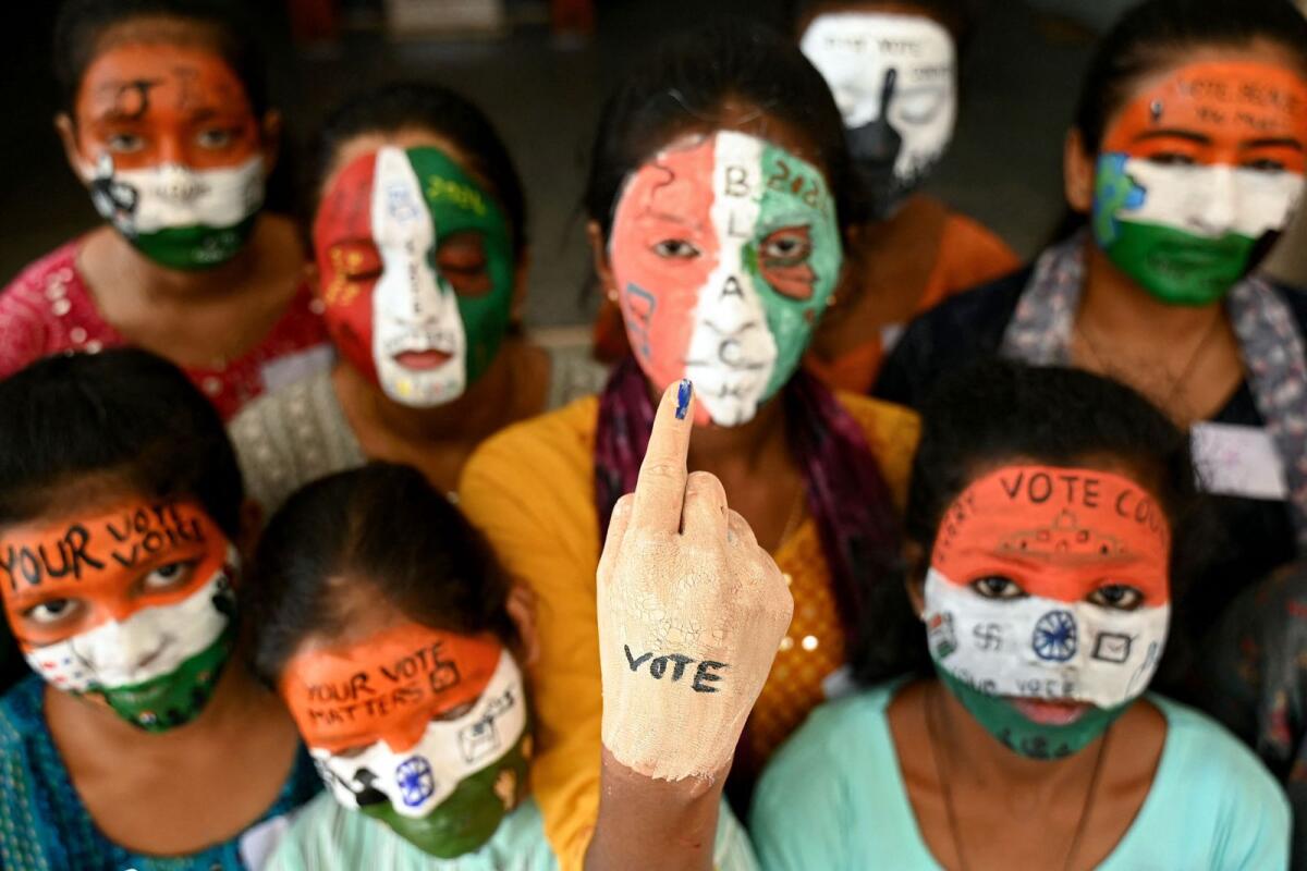 College students with painted faces spread awareness for first generation voters during an election campaign ahead of India's upcoming national elections in Chennai on March 19, 2024.  — AFP file