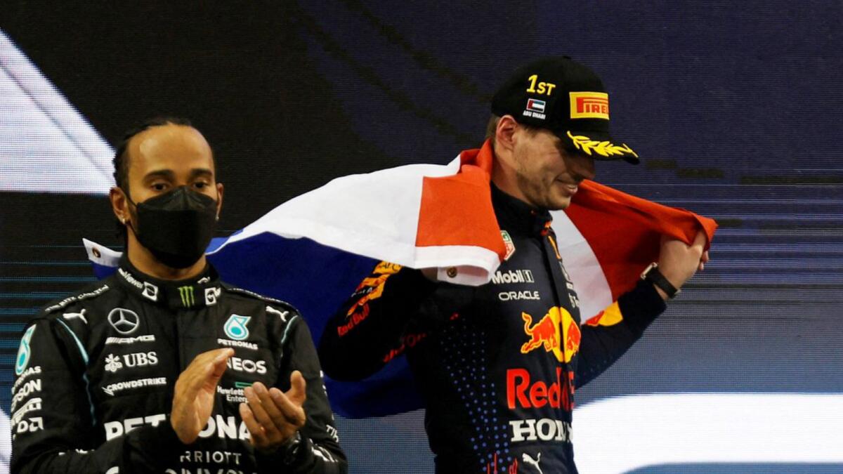 Max Verstappen (right) celebrates after winning the F1 world title ahead of Lewis Hamilton, at the season finale in Abu Dhabi last year. — Reuters