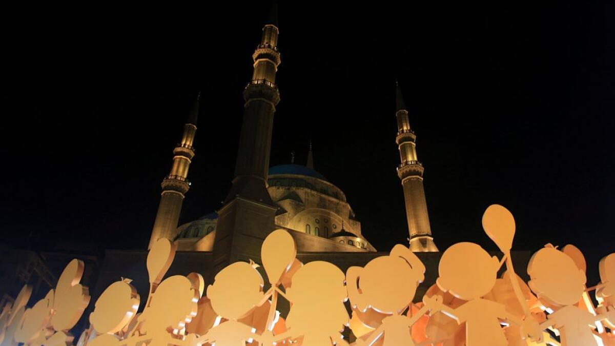 A decoration depicting dancing orphans is placed in front of al Amin mosque ahead of Ramadan in Beirut, Lebanon.