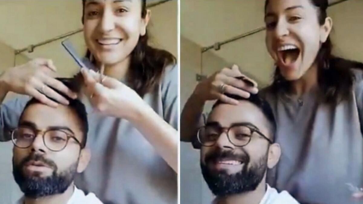Indian cricket captain Virat Kohli gets a haircut from his wife Anushka Sharma in this picture grab from a video post shared by Anushka. - Twitter