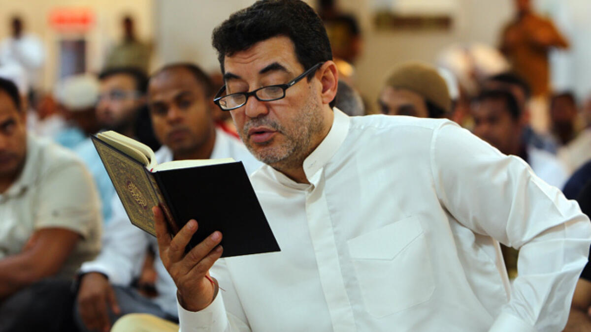 A devotee reads the Holy Quran at Rashidiya Grand Mosque, Dubai.