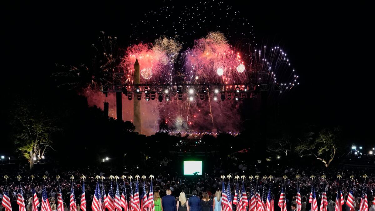 US President Donald Trump, First Lady Melania Trump and family members stand to watch fireworks after the president delivered his acceptance speech for the Republican Party nomination for reelection during the final day of the Republican National Convention from the South Lawn of the White House in Washington, DC. Photo: AFP
