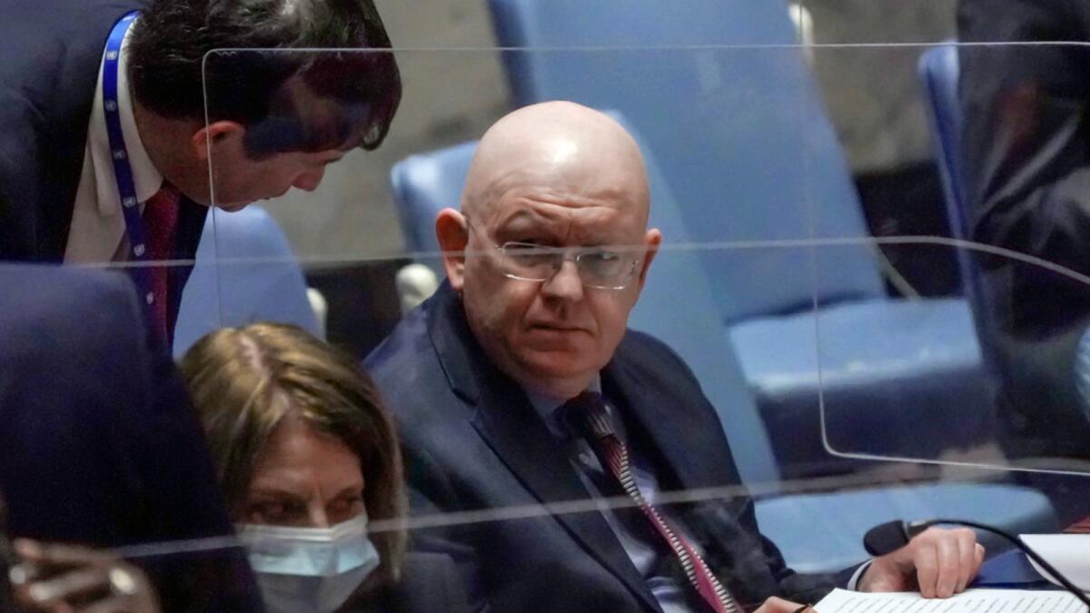Russia Ambassador Vassily Nebenzia confers during a meeting of the United Nations Security Council on the humanitarian crisis in Ukraine. — AP