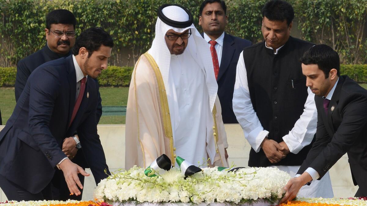 His Highness Shaikh Mohammed bin Zayed Al Nahyan, Crown Prince of Abu Dhabi and Deputy Supreme Commander of the UAE Armed Forces, scatters rose petals at Mahatma Gandhi Memorial at Raj Ghat in New Delhi, India, February 11, 2016. -