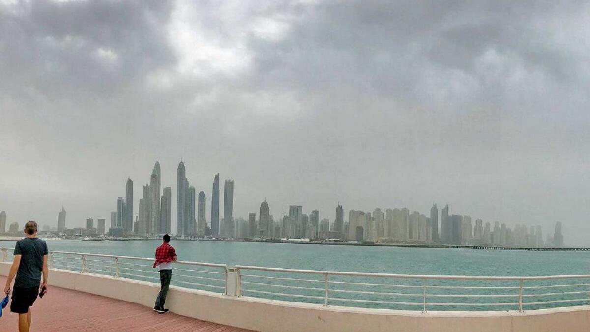 Dark clouds tower over the Dubai skyline as seen from the Dubai Marina. 