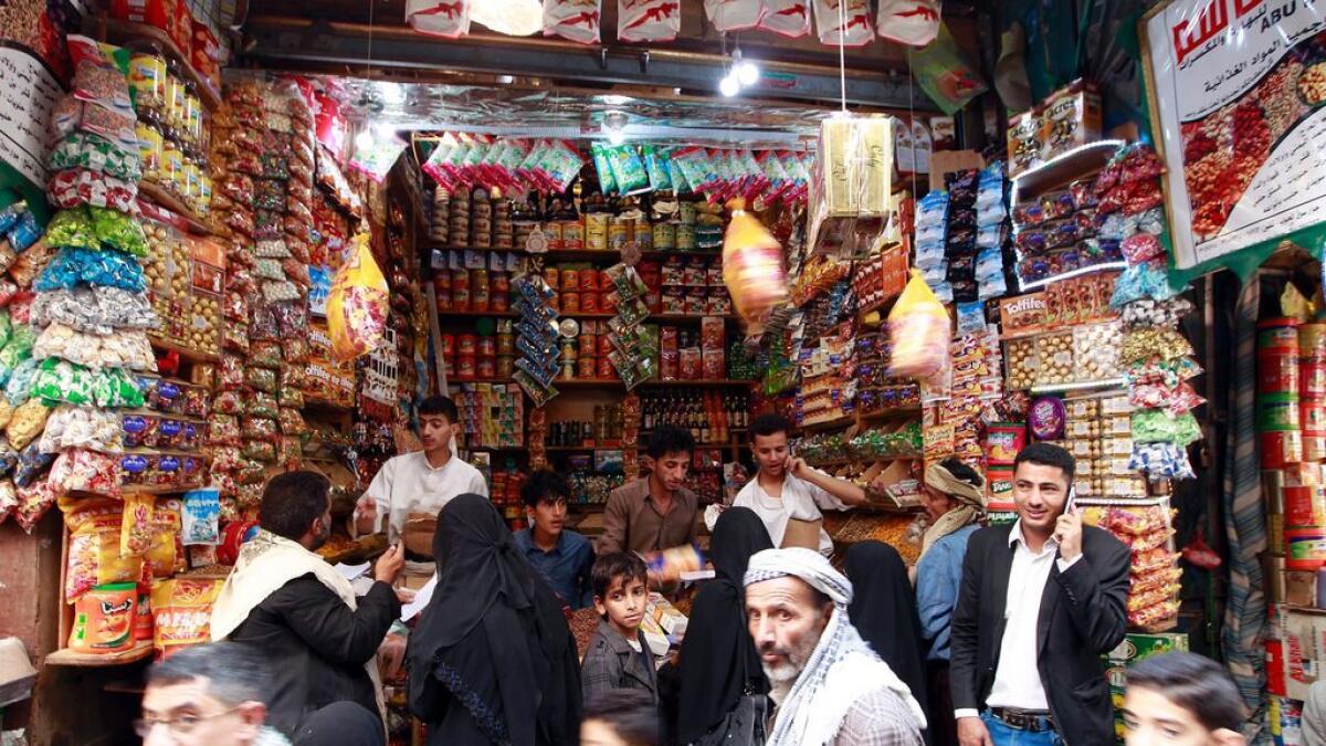 Yemeni shop owners sell sweets in the capital Sanaa on July 3, 2016, ahead of the Muslim holiday of Eid al-Fitr marking the end of the holy fasting month of Ramadan.