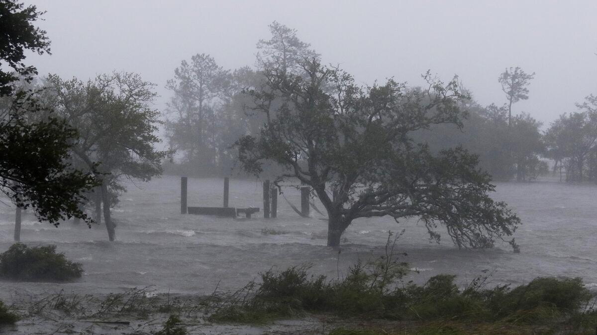 Hurricane Florence rolls ashore in Carolinas, tears buildings apart