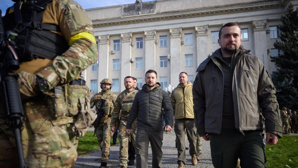 Ukrainian President Volodymyr Zelensky (C) arriving to visit the newly liberated city of Kherson, following the retreat of Russian forces from the strategic hub. — AFP