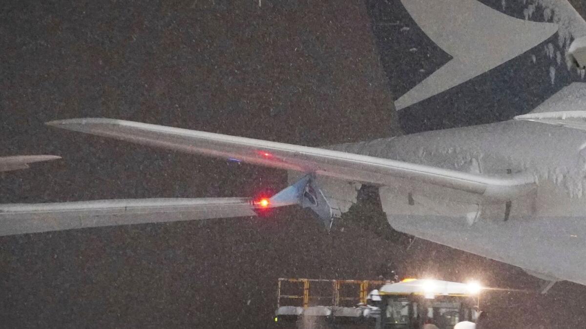 A part of the wing of Korean Air (left) and Cathay Pacific aircraft are seen after a collision at New Chitose Airport in Sapporo on Tuesday. Photo: AP
