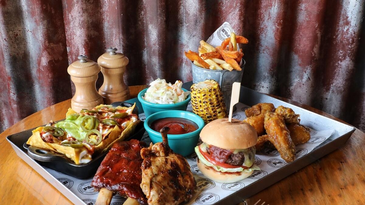 BY: PERRY &amp; BLACKWELDER’S.The Souk Madinat Jumeirah smokehouse is brewing up an extravaganza today with a special all-American menu for Dhs199 per pair, as well as other exciting offers for the summer, including a ‘99ers’ (two-courses Dhs99) lunch deal and special late night nibbles menu. As with most Yankee dining establishments: try the burger.On: Today