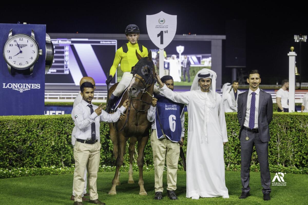 Taakeed (Ben Cohen) winner of the Beach Oasis by Azizi handicap with Mohammed Al Shehhi, ERA General Manager and trainer Michael Costa. – Photo by Dubai Racing