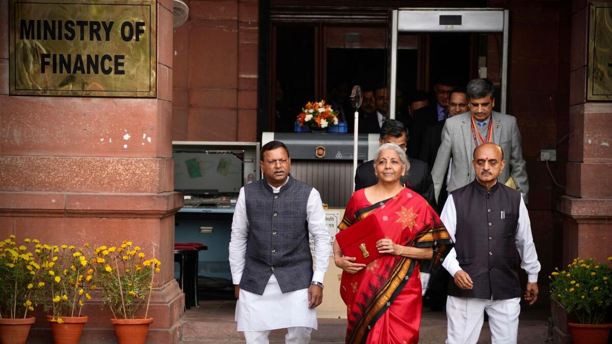 Indian Finance Minister Nirmala Sitharaman, in red, leaves her office for President's house before presenting the federal budget for the financial year 2023-24 in the Parliament in New Delhi on Wednesday. - AP